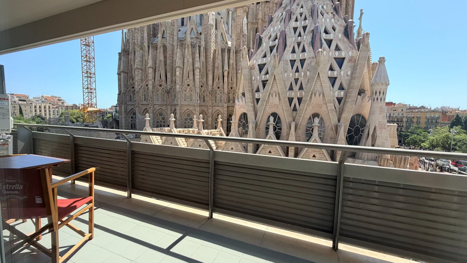 Balcony seating with a chair and small table, Sagrada Familia in the background